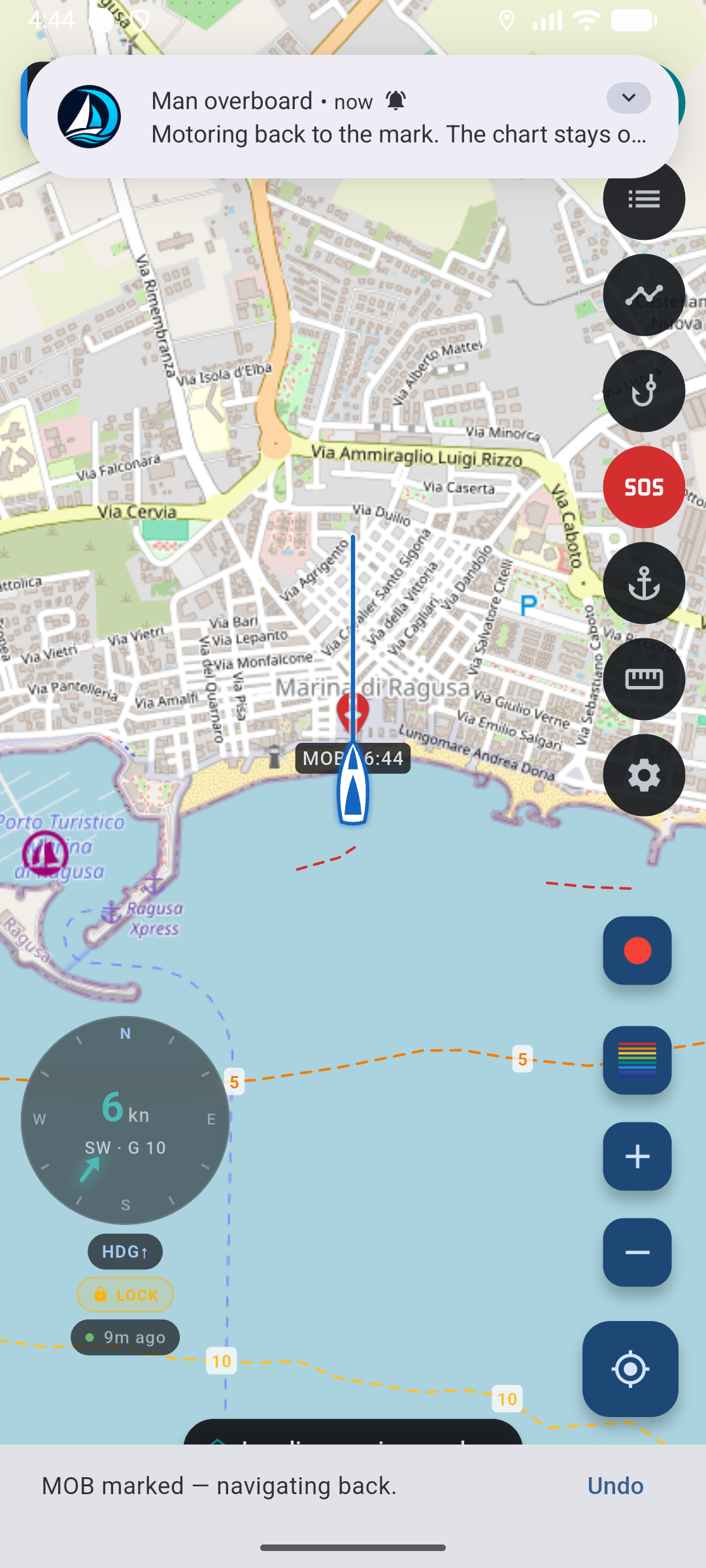 MOB under way: red person pin MOB 21:39, engine rhumb 0.30 NM, SOS button filled red, Undo on the snackbar.